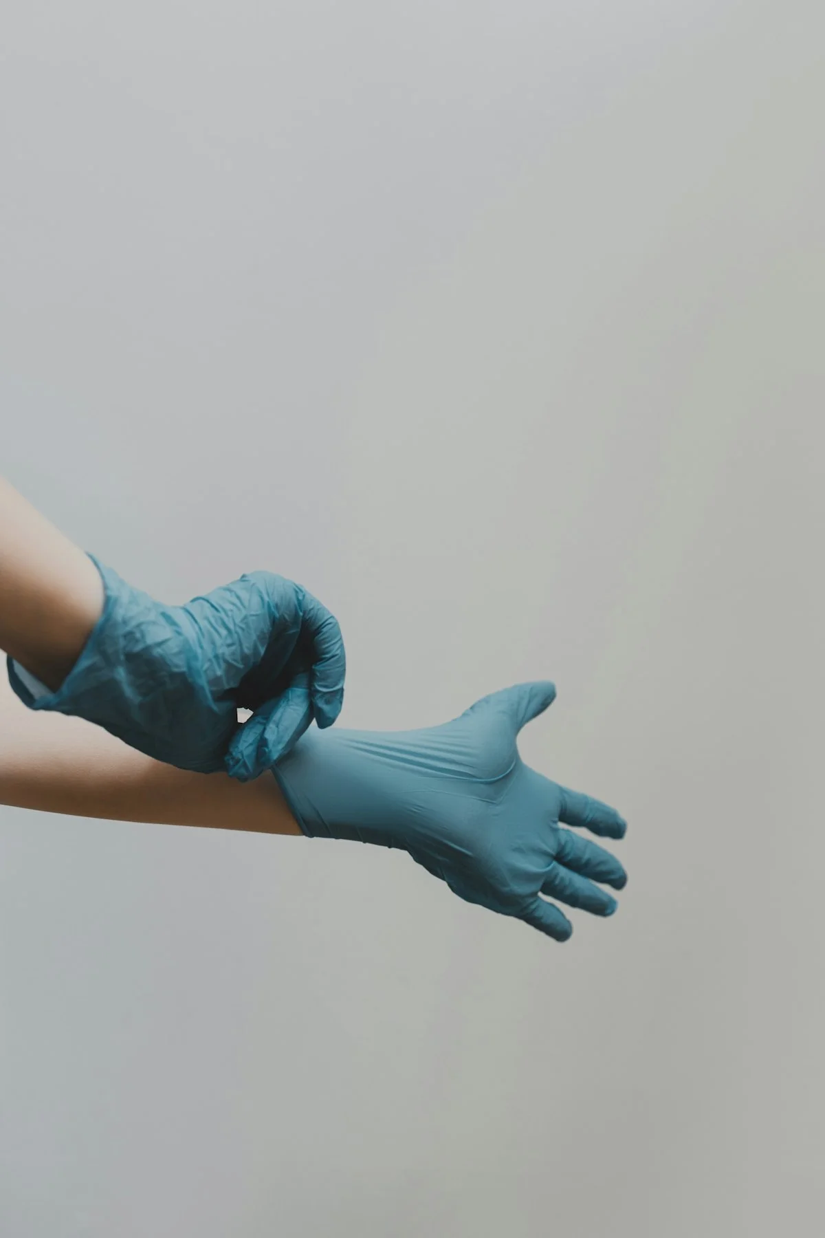 Clean, neatly folded lab coats and scrubs on a shelf